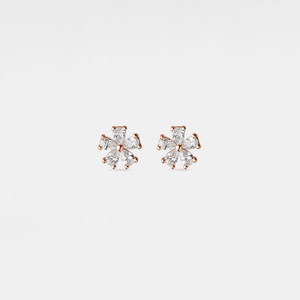 Pair of rose gold earrings with clear gemstones on a light gray background