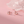 Rose gold swan-shaped earrings on a pink background