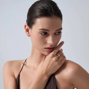 Woman with a ring on her finger against a plain background