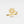 Gold flower-shaped ring with gemstones on a light gray background