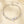 Silver bracelet with clear gemstones on a beige background