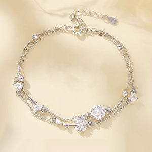 Silver bracelet with clear gemstones on a beige background