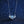 Silver necklace with a heart-shaped pendant featuring a blue gemstone on a dark blue glittery background.