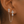 Silver cross earrings with chains worn on an ear