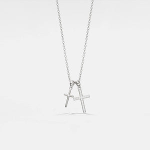 Silver necklace with a bow and 'A' pendant on a light gray background