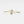 Gold bracelet with two round gemstones on a light gray background