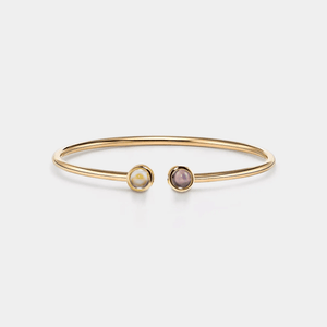 A gold-plated sterling silver bangle bracelet with two circular photo projection charms.