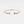 Gold bracelet with embedded stones on a light gray background