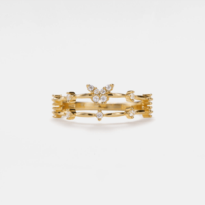 Gold ring with butterfly design on a white background