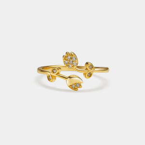 Gold ring with floral design on a white background