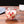 Clear glass mug with red floral design on a wooden surface