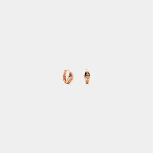 Rose gold hoop earrings on a light gray background