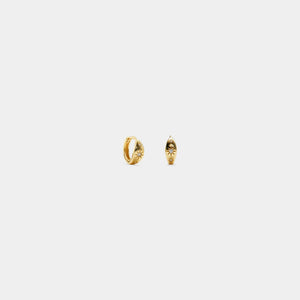 Gold hoop earrings on a light gray background