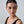 Woman wearing a black top against a gray background