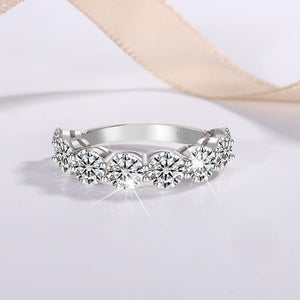 Silver ring with multiple gemstones on a light background