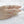 Hand wearing a ring on a textured white surface