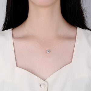 Necklace with a small pendant on a person wearing a white shirt