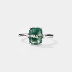 Ring with a green gemstone on a white background