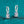 Silver hoop earrings with rectangular gemstones on a teal glitter background