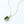 Gold necklace with a green gemstone pendant on a white background