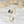 Gold ring with a green gemstone on a textured white background