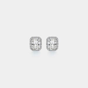 Pair of diamond stud earrings on a light gray background