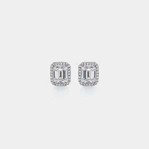 Pair of diamond earrings on a light gray background