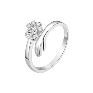 Silver ring with paw print design on a white background