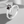Silver ring with a paw print design on a light gray background