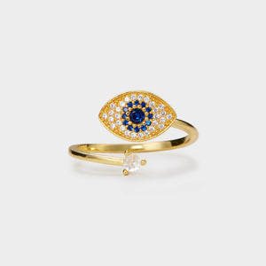 A gold-plated sterling silver fidget spinner ring with a blue and clear cubic zirconia evil eye design