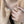 Women wearing a gold spinner ring with a evil eye compass design