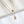 Two gold necklaces with eye-shaped pendants on a white background