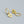 A pair of heart-shaped dangle drop hoop earrings with an evil eye design, made of solid 925 sterling silver and gold plating, displayed against a neutral background.