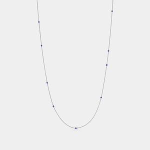A gold-plated sterling silver necklace with a small blue enamel charm representing the 'evil eye', linked with a chain of smaller gold-plated charms.