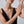 Woman wearing a gold bracelet on a plain background