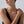 Woman wearing a delicate bracelet on a plain background