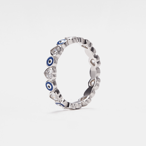 A white gold-plated sterling silver stacking ring with blue enamel evil eyes and heart-shaped cubic zirconia accents