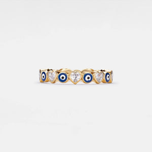 A gold-plated sterling silver stacking ring with blue enamel evil eyes and heart-shaped cubic zirconia accents