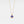 Gold necklace with a blue evil eye pendant on a light gray background
