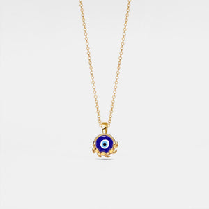Gold necklace with a blue evil eye pendant on a light gray background