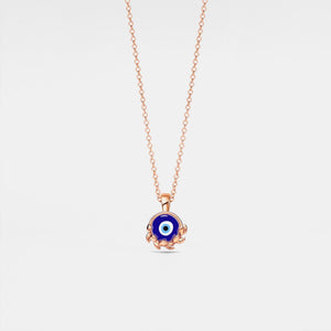 Rose gold necklace with a blue evil eye pendant on a light gray background