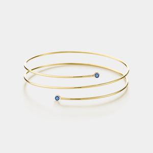 Gold bangles with blue beads on a white background