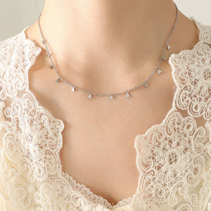 Necklace with triangle pendants on a lace garment