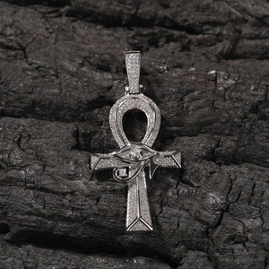 A gold-plated Egyptian Ankh necklace with cubic zirconia accents, displayed on a black fabric background.