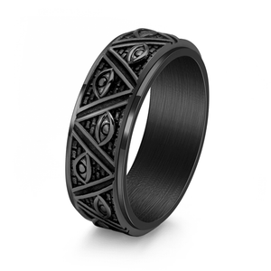 Black metal ring with intricate designs on a white background