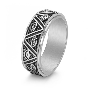Silver ring with intricate black designs on a white background