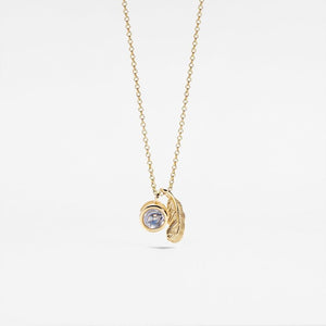 Gold necklace with a pendant on a light gray background