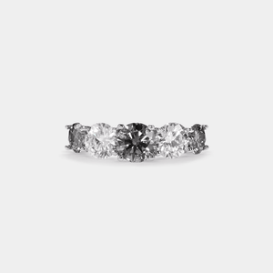 A five-stone color moissanite cocktail ring with alternating pink andlessen clear stones, set in a silver band with hypoallergenic plating.