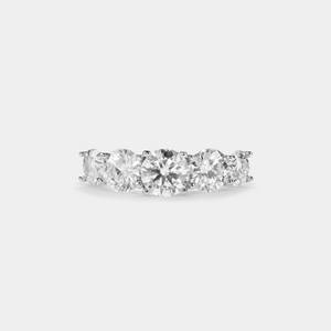 A five-stone color moissanite cocktail ring with alternating pink andlessen clear stones, set in a silver band with hypoallergenic plating.