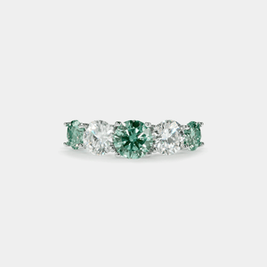 A five-stone color moissanite cocktail ring with alternating pink andlessen clear stones, set in a silver band with hypoallergenic plating.